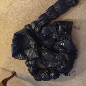 Black shiny puffer coat. Buckle sinch waist, cowl neck w/zip and buttons.